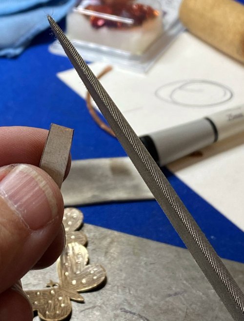 Susan LeGuyader's Butterfly Earrings - , Contemporary Wire Jewelry, Dapping, Dapping Jewelry, How To Punch Holes, Hole Punching, Punch A Hole, Texturing, Butane Torch, Soldering, Solder, Hold the butterfly against the titanium strip 